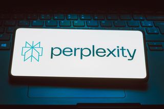 Perplexity AI logo displayed on a smartphone sitting on a laptop keyboard