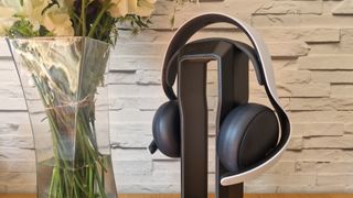 A close up picture of the PlayStation Pulse Elite headset next to a vase