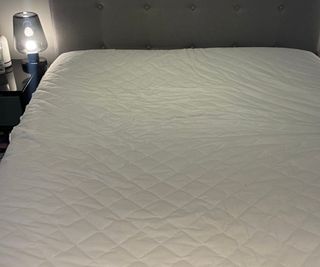 The Amazon Basics Mattress Protector on the bed during testing