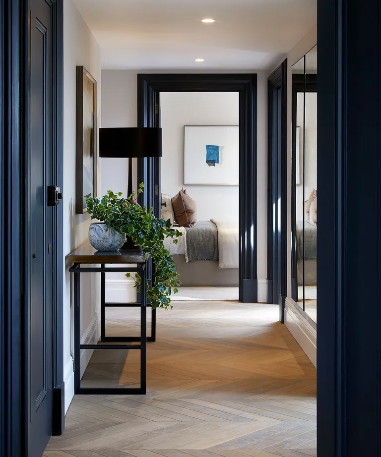 Dark blue paintwork in a hallway with console table