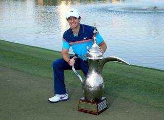 Rory McIlroy poses with the Dubai Desert Classic trophy