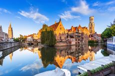 The Rozenhoedkaai canal in Bruges with the Belfry in the background.