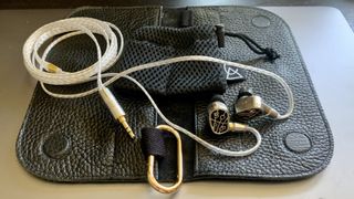 Campfire Audio Solaris Stellar Horizon on its black leather case, silver background