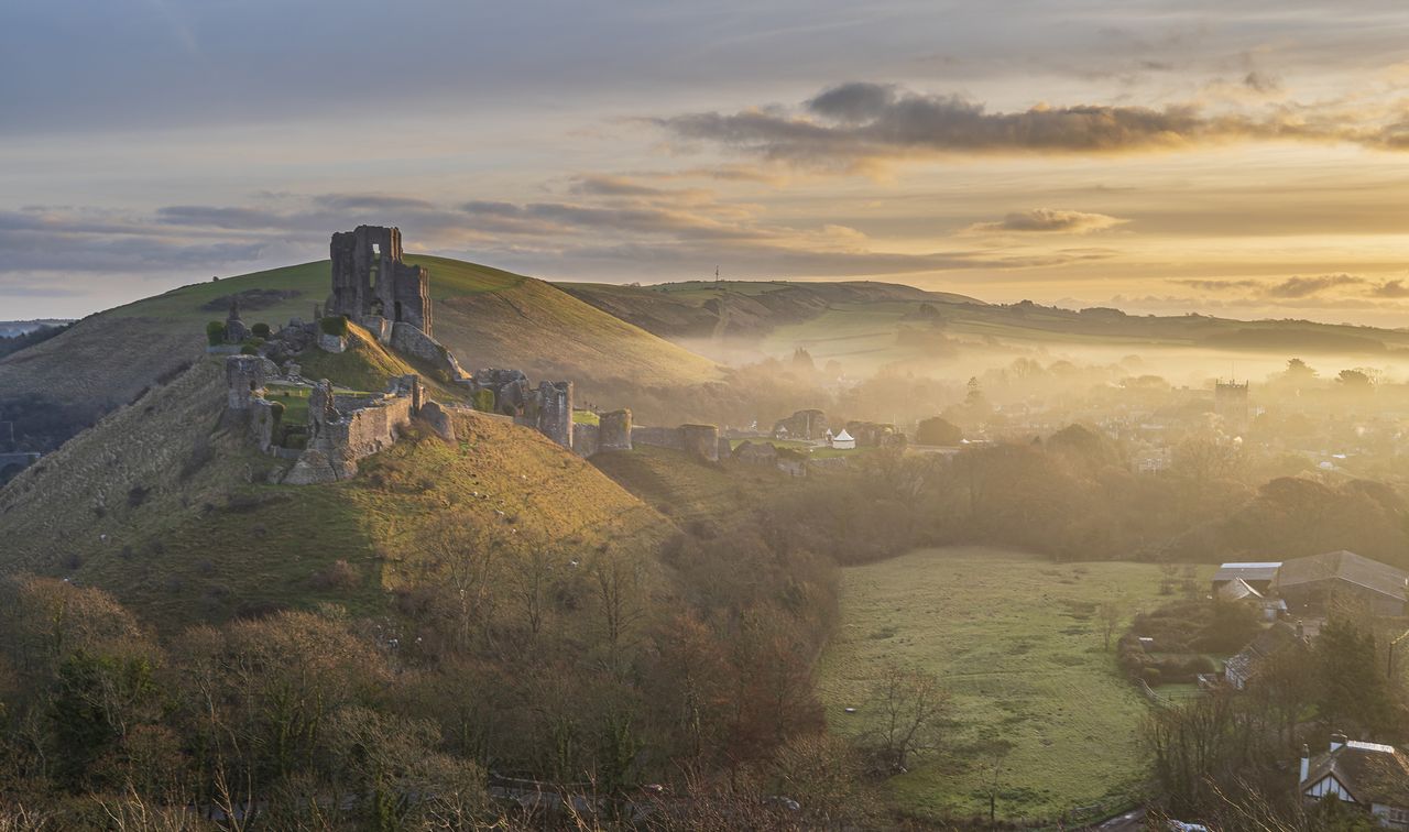 Morning light at Corfe Castle, Dorset where conservators are carrying out a £2 million project to conserve the castle walls.