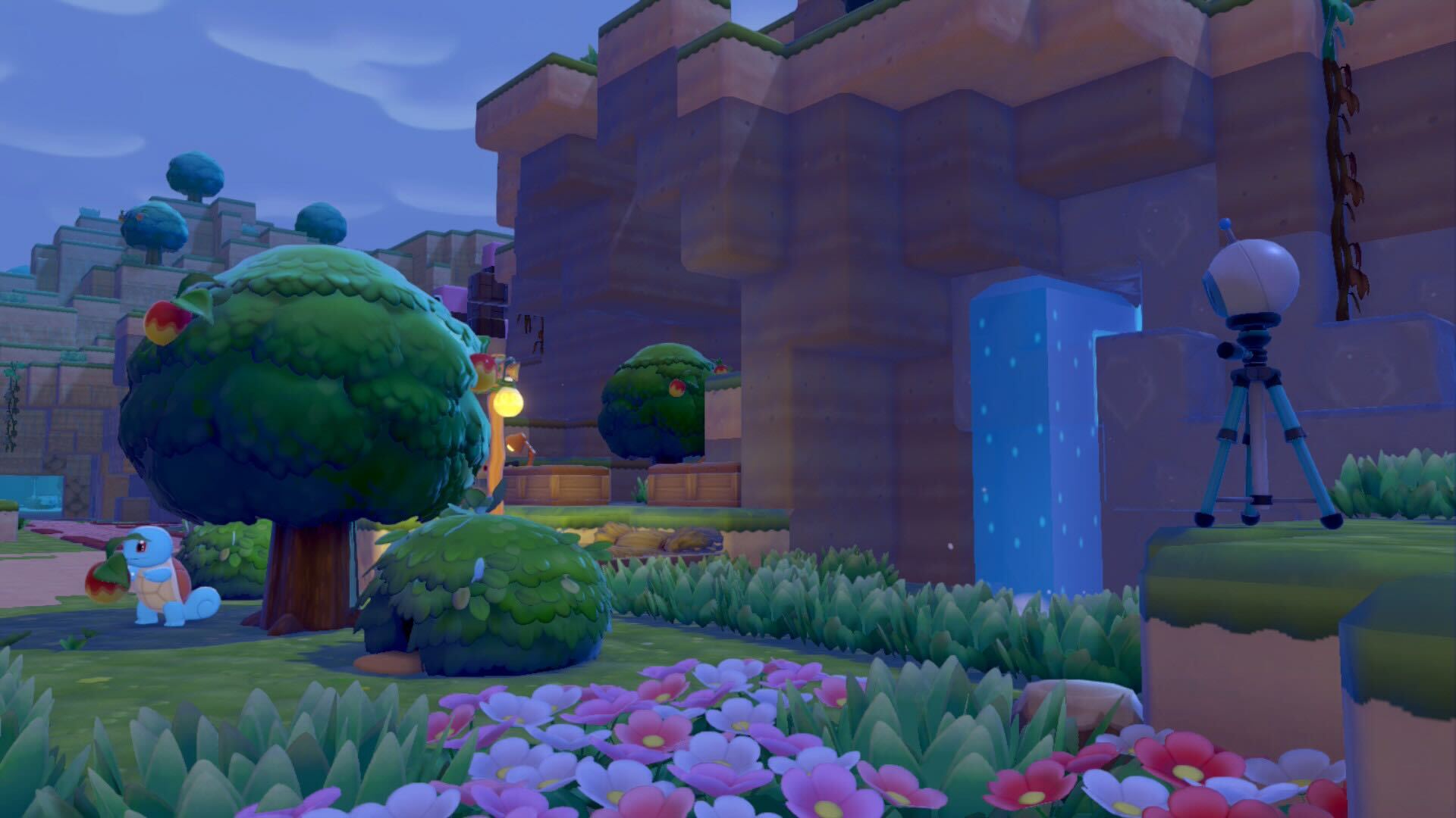 A security camera looking over a lush green landscape with flowers and a waterfall in Pokemon Pokopia