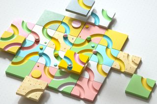 An abstract depiction of colourful wooden blocks covered with concave paths