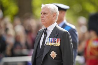 Prince Andrew wearing a gray suit with medals