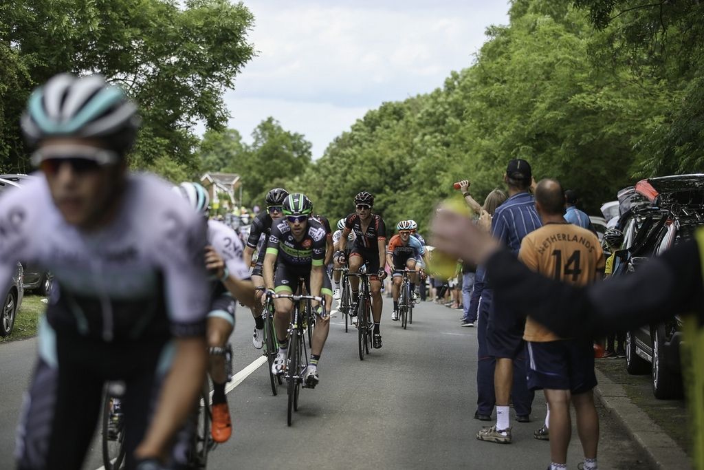 Fans cheer on the peloton