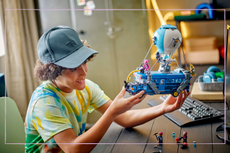 boy holding LEGO creation