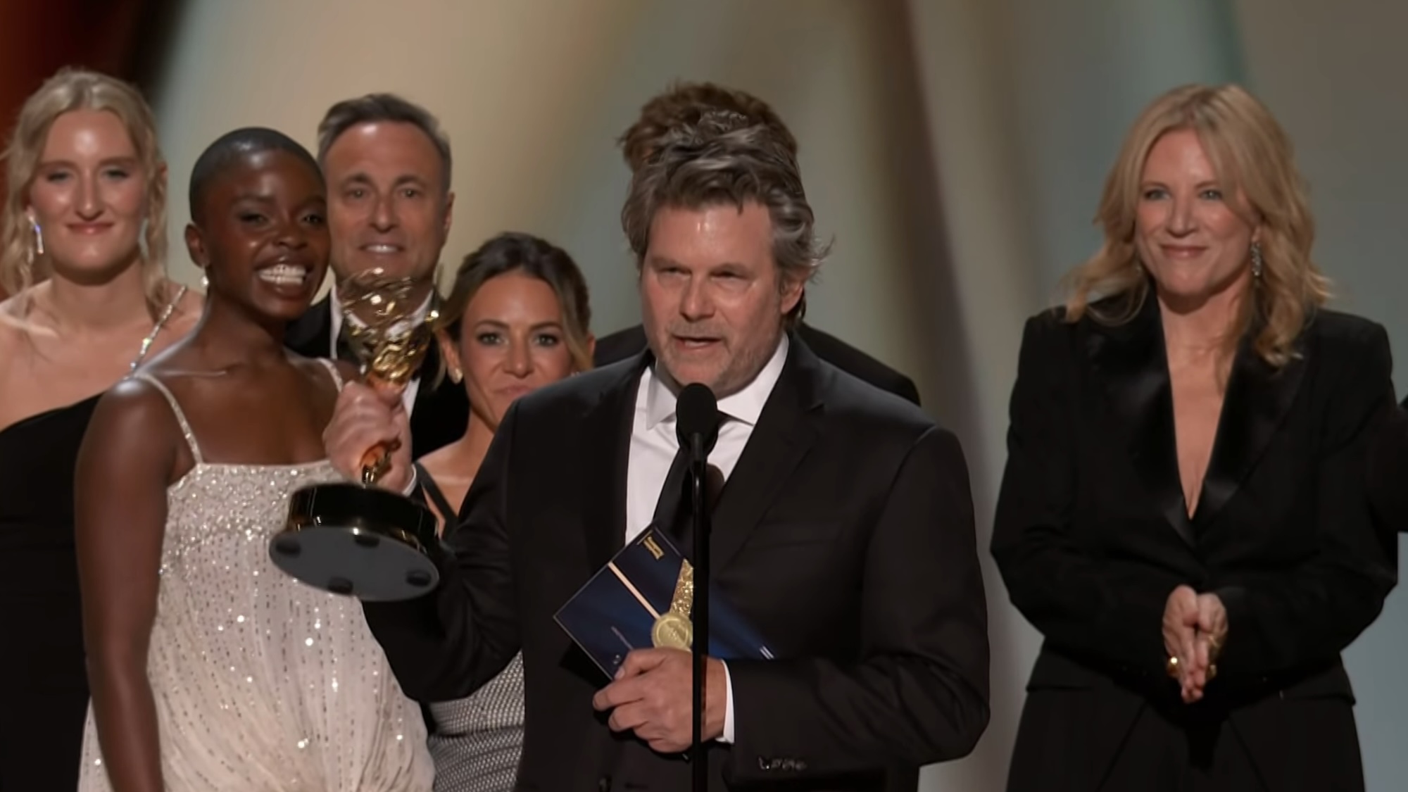 Steven Conrad accepting award with DTF St Louis cast on stage at 2026 Emmys