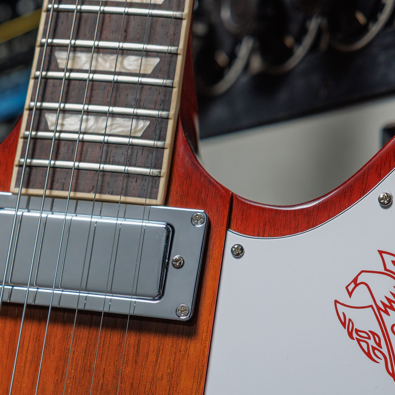 A photo showing a detail of the Gibson Firebird Platypus guitar in a recording studio setting