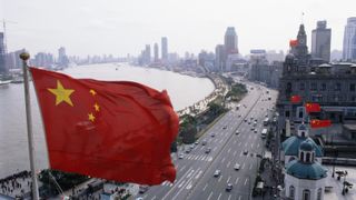 A Chinese flag flies high over The Bund.