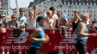 Spectators watch runners in the London Marathon