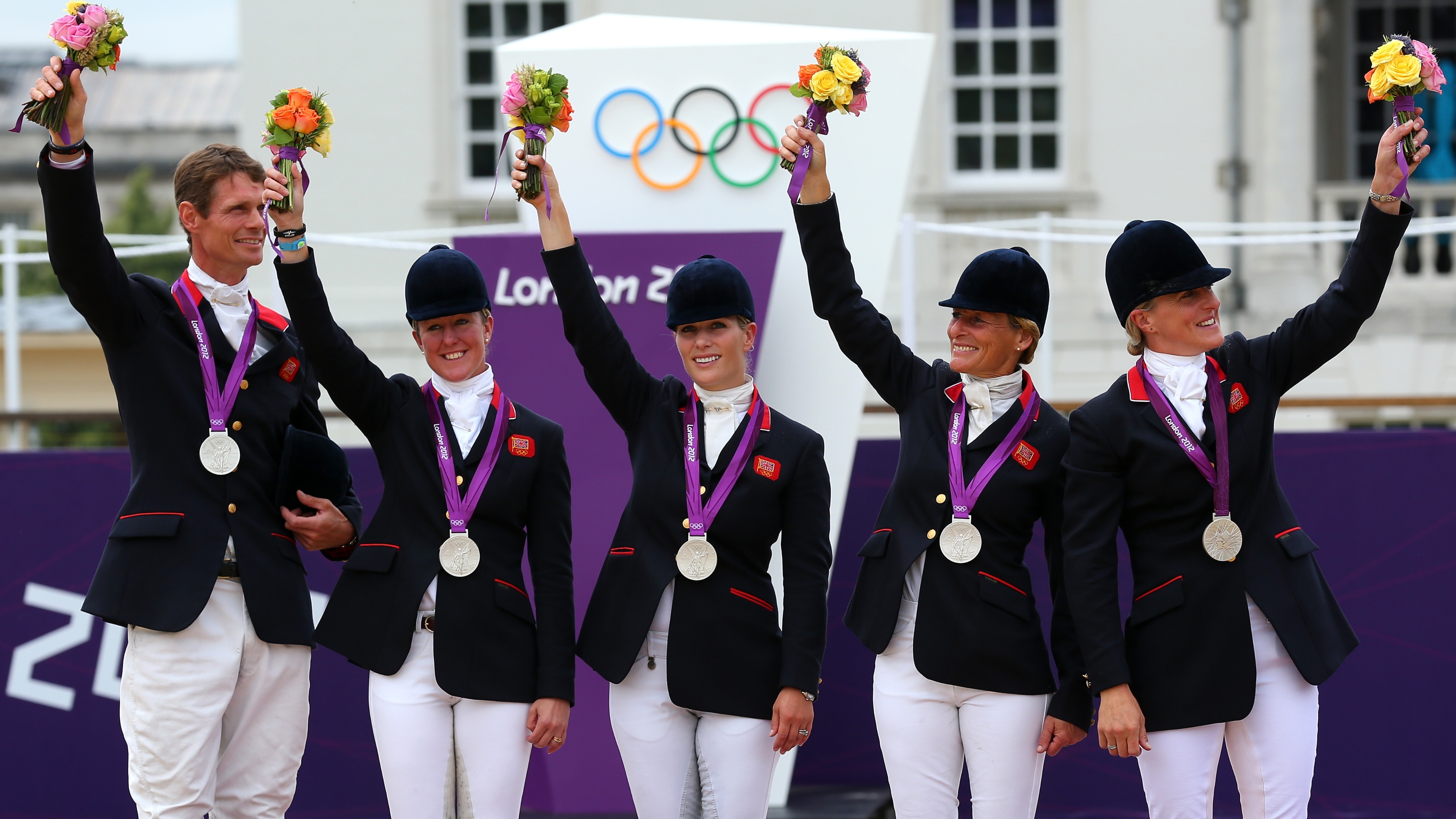 The Great Britain team celebrate on the podium after winning the Silver medal in the Eventing Team Jumping Final Equestrian event on Day 4 of the London 2012 Olympic Games