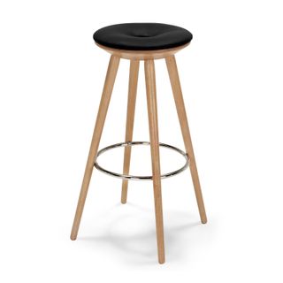 Circular brown bar stool with leather seat and tapered wooden legs