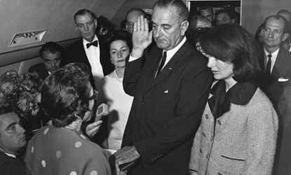 Lyndon B. Johnson takes the oath of office aboard Air Force One after the assassination of John F. Kennedy on Nov. 22, 1963.