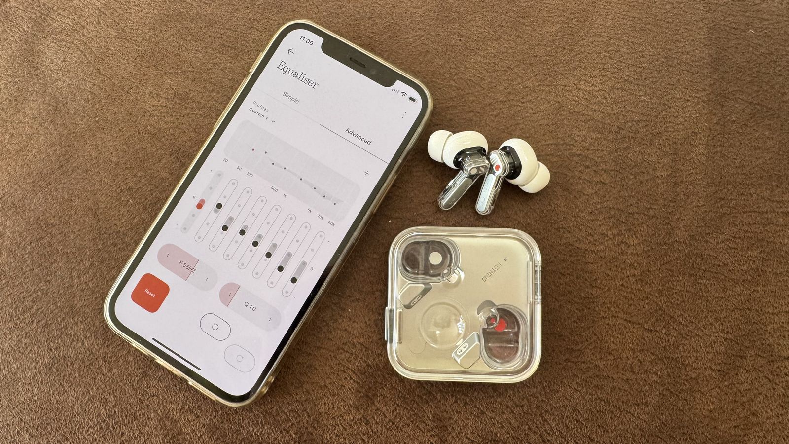 Nothing Ear (3) earbuds beside a phone with the advanced EQ filter showing
