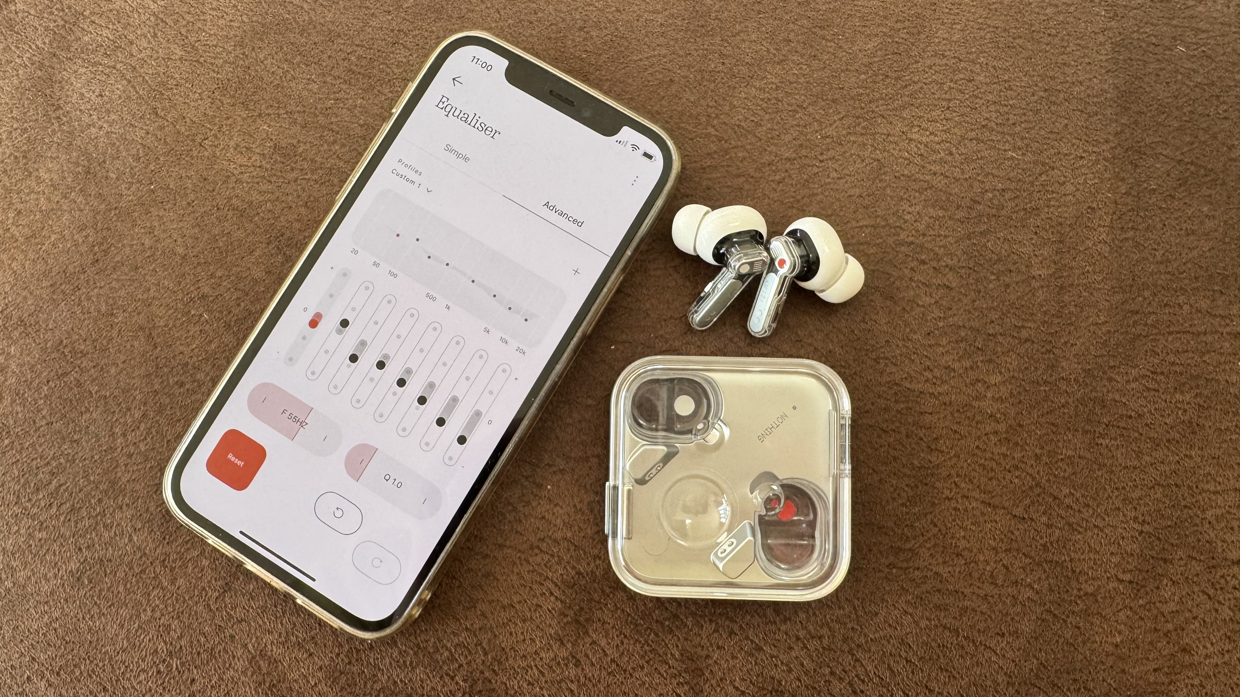 Nothing Ear (3) earbuds beside a phone with the advanced EQ filter showing