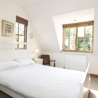 bedroom with white wall and white bedlinen