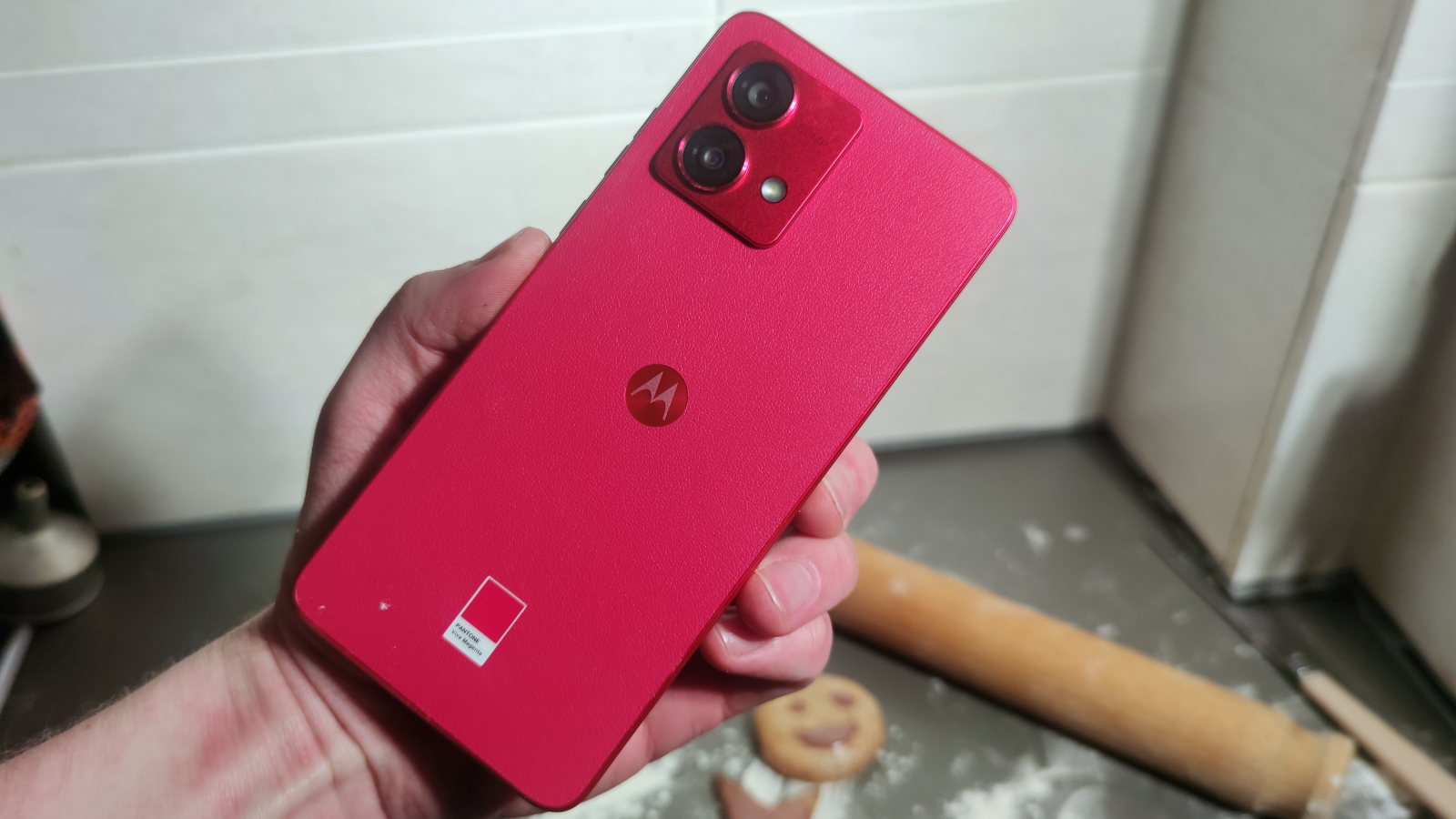 The Moto G84 in the hand