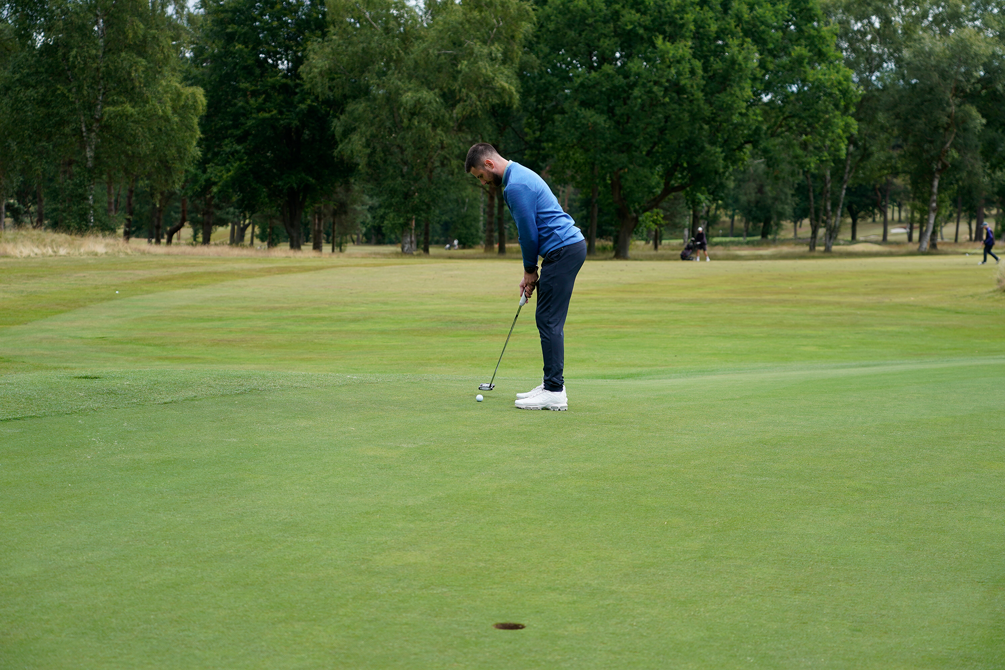 Baz Plummer just before impact in his putting stroke on the 2nd green at Sand Moor Golf Club