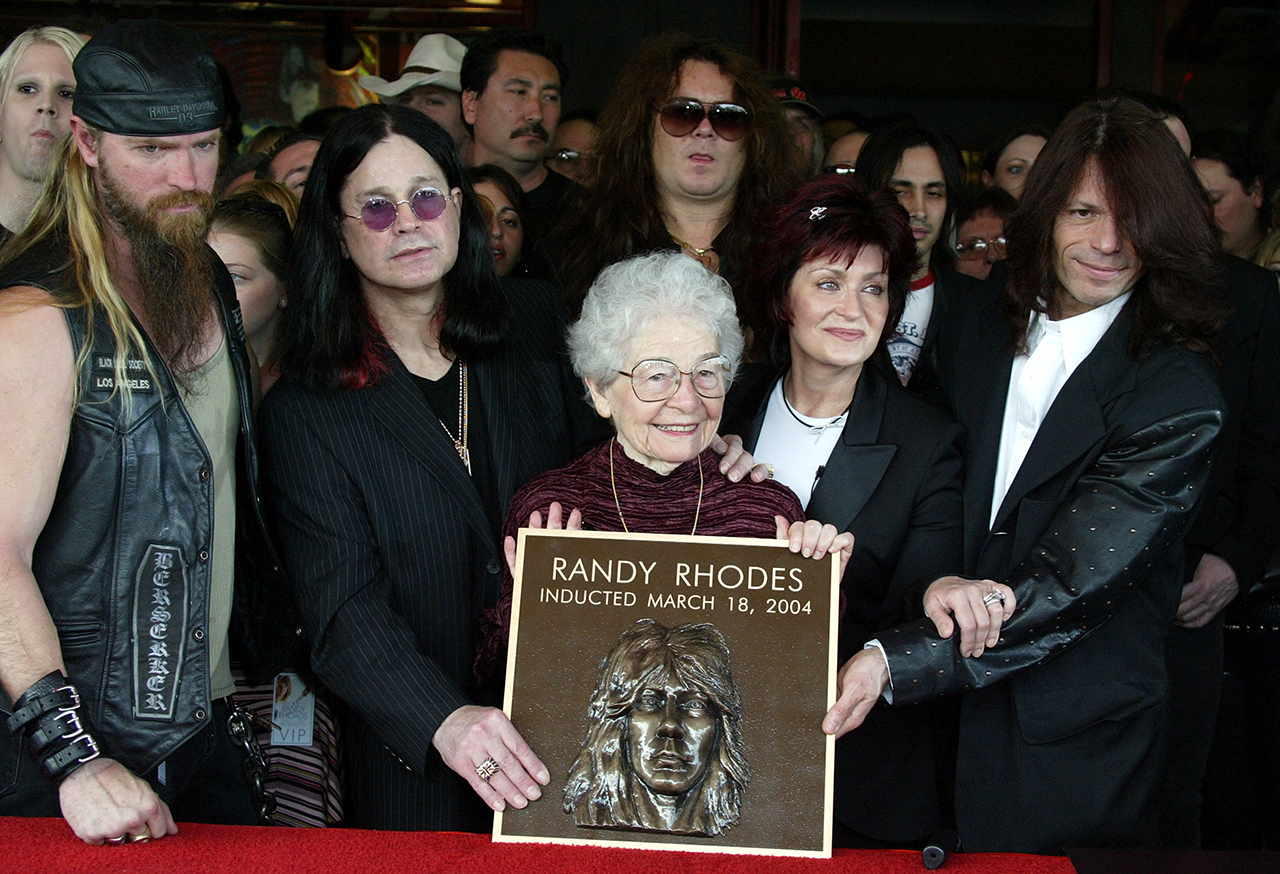 HOLLYWOOD - MARCH 18: The mother of Randy Rhoads, Delores Rhoads, along with rockers (L-R) Zakk Wylde, Ozzy Osbourne, guitarist Yngwie Malmsteen, Sharon Osbourne and Rudy Sarzo attend the ceremony in which former guitarist Randy Rhoads was honored posthumously and inducted into the Hollywood Rockwalk on March 18, 2004 in Hollywood, California. (Photo by Frazer Harrison/Getty Images)