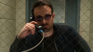 Matt Murdock holding a phone to his right ear in a prison in Daredevil: Born Again episode 2