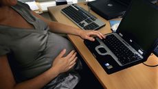 A pregnant woman is seen at the office work station on July 18, 2005 in London, England.