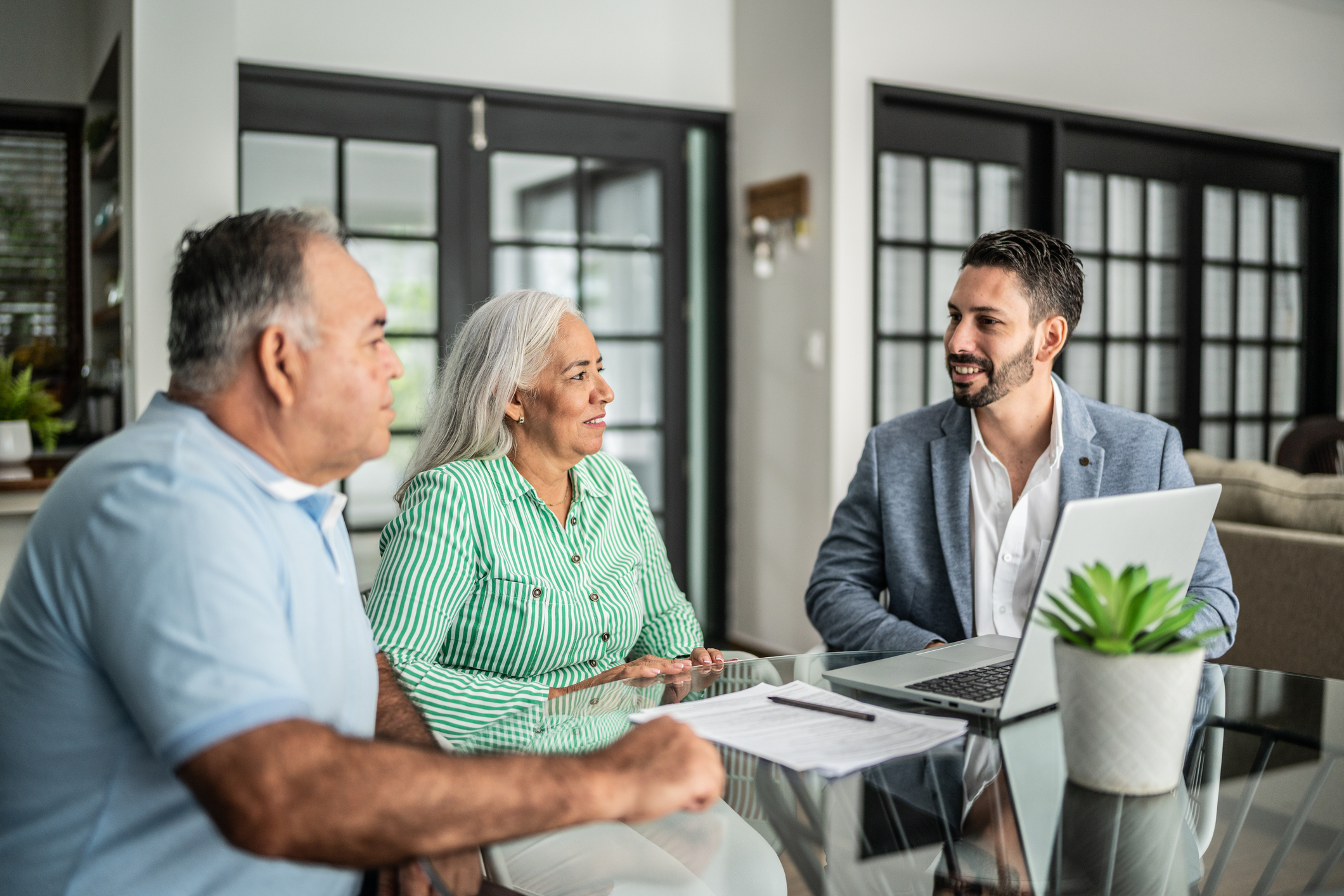 Financial advisor having a meeting with senior couple at home