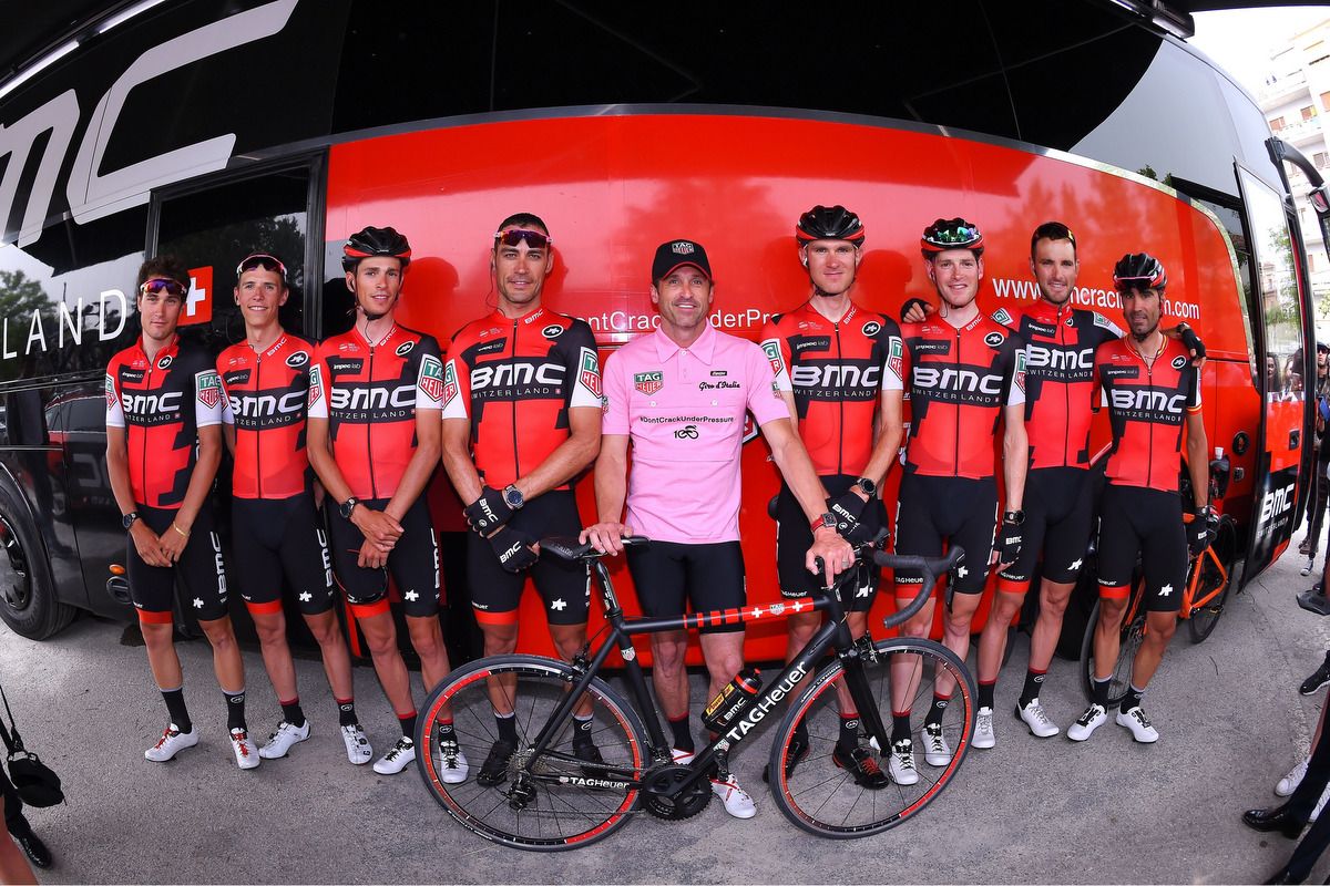 Actor Patrick Dempsey poses for photos with the BMC team on the morning of stage 7