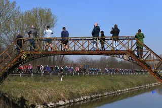 SANREMO ITALY MARCH 20 The Peloton during the 112th MilanoSanremo 2021 a 299km race from Milano to Sanremo Bridge Fans Public Landscape MilanoSanremo La Classicissima UCIWT on March 20 2021 in Sanremo Italy Photo by Tim de WaeleGetty Images