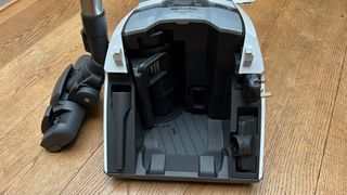 Inside the bin section of Miele Blizzard CX1 canister vacuum, showing tool storage