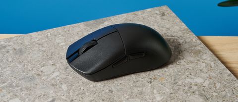 A black Lemokey G1 wireless gaming mouse sitting on a marble slab