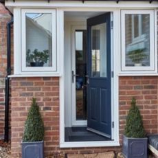red brick front porch with door leading to home