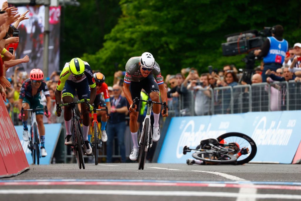 TOPSHOT Team AlpecinFenix Dutch rider Mathieu van der Poel C sprints on his way to win ahead of Team Wantys Eritrean rider Biniam Girmay Hailu L and as Team Lottos Australian rider Caleb Ewan Rear R falls the first stage of the Giro dItalia 2022 cycling race 195 kilometers between Budapest and Visegrad Hungary on May 6 2022 Photo by Luca Bettini AFP Photo by LUCA BETTINIAFP via Getty Images