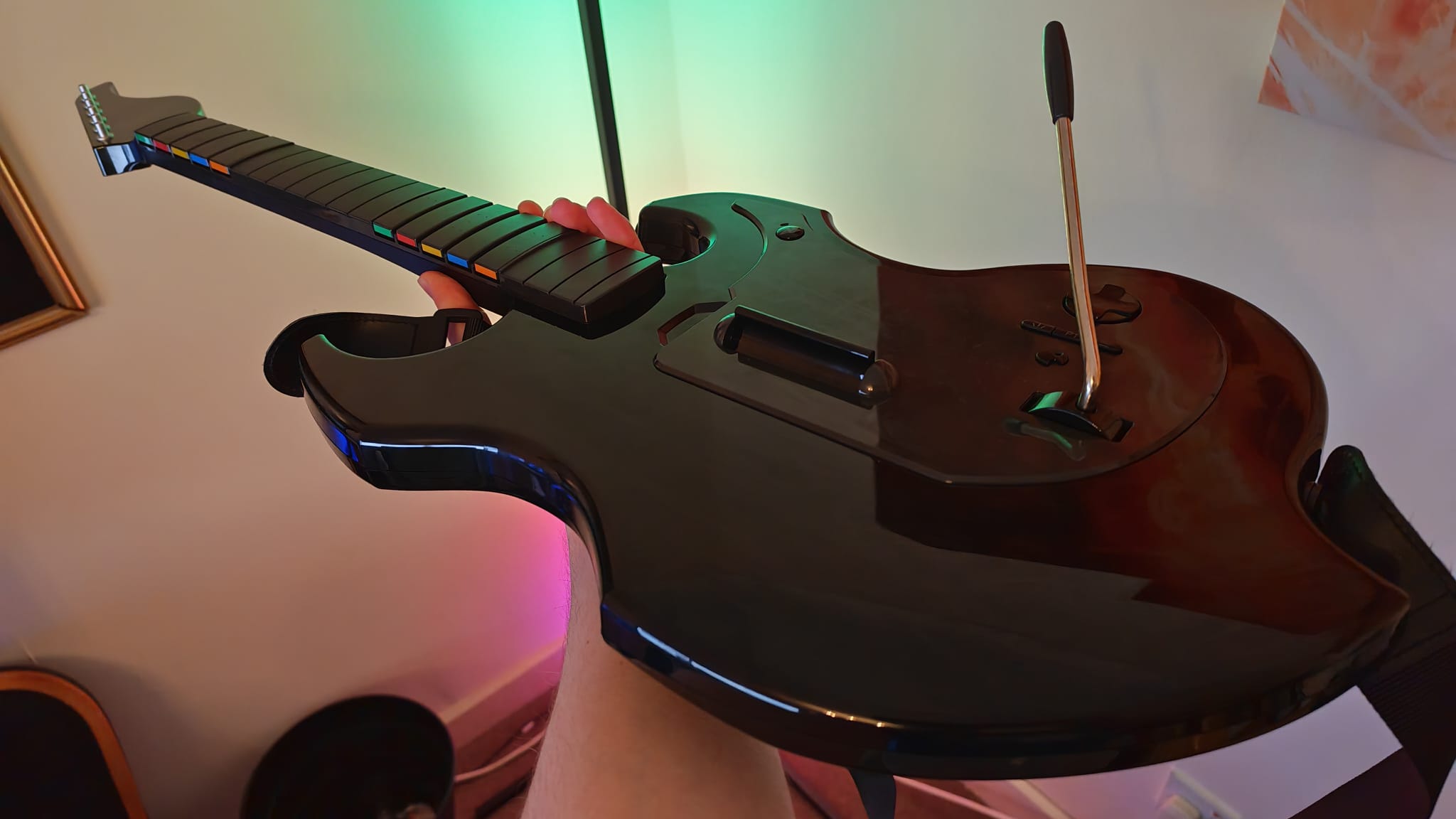 A reviewer showing off the PDP Riffmaster Guitar in front of some RGB lighting