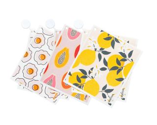 Three reusable paper towels in colorful patterns