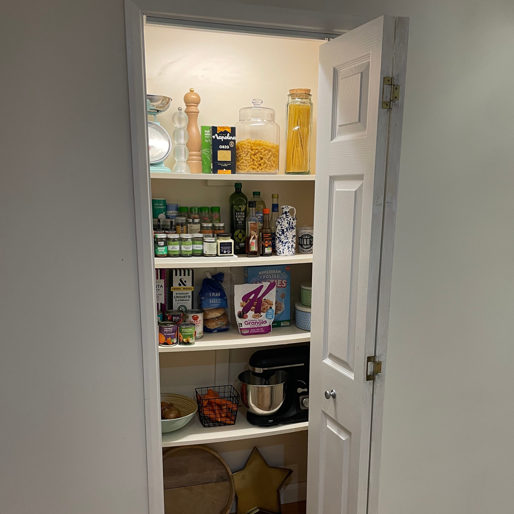 a small pantry with bifold door