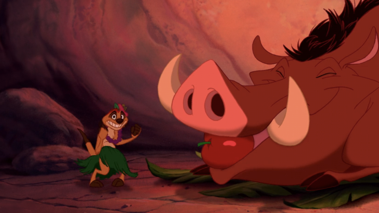 Timon singing in Luau outfit with Pumbaa with apple in his mouth in The Lion King