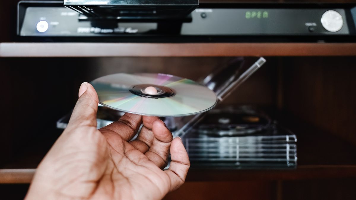 Close-up of unrecognizable woman selecting DVD to watch