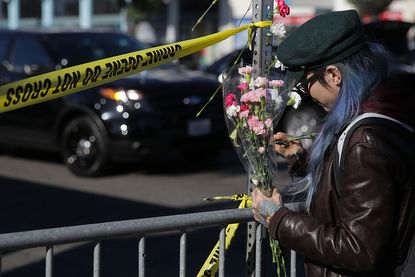 A woman mourns those lost in an Oakland warehouse fire