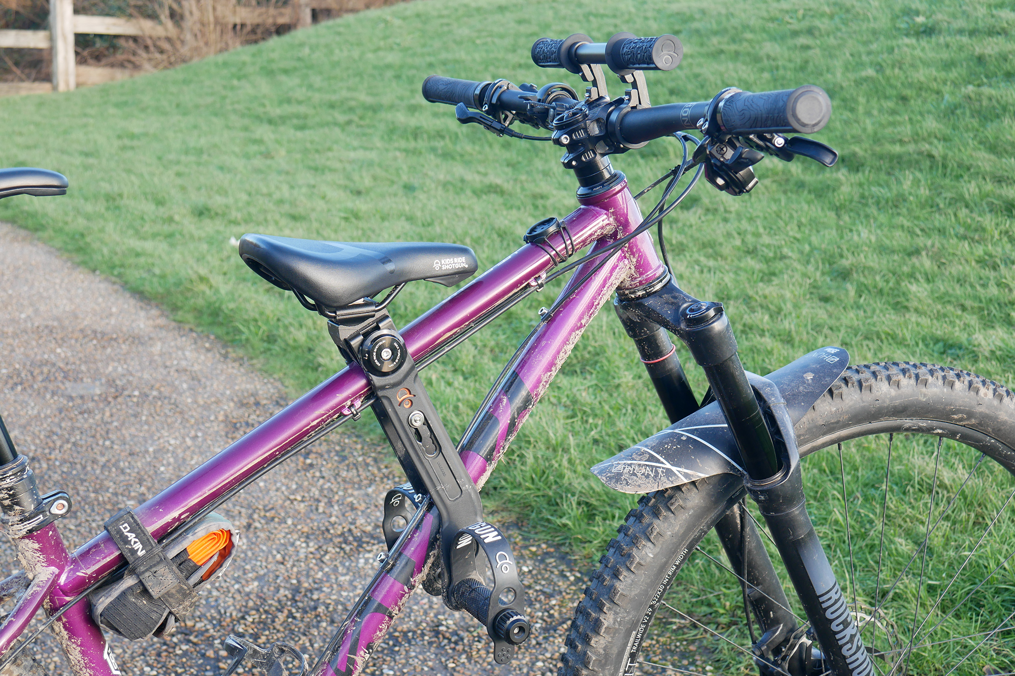 Kids Ride Shotgun 2.0 Combo seat and Handlebar mounted to a Cotic Solaris Max hardtail mountain bike in purple.