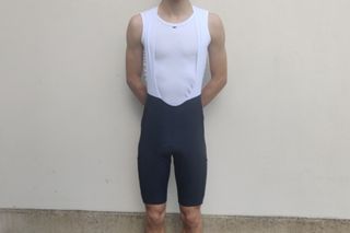 Image shows a rider wearing the Rapha Core Cargo bib shorts which are among the best bib shorts for cycling