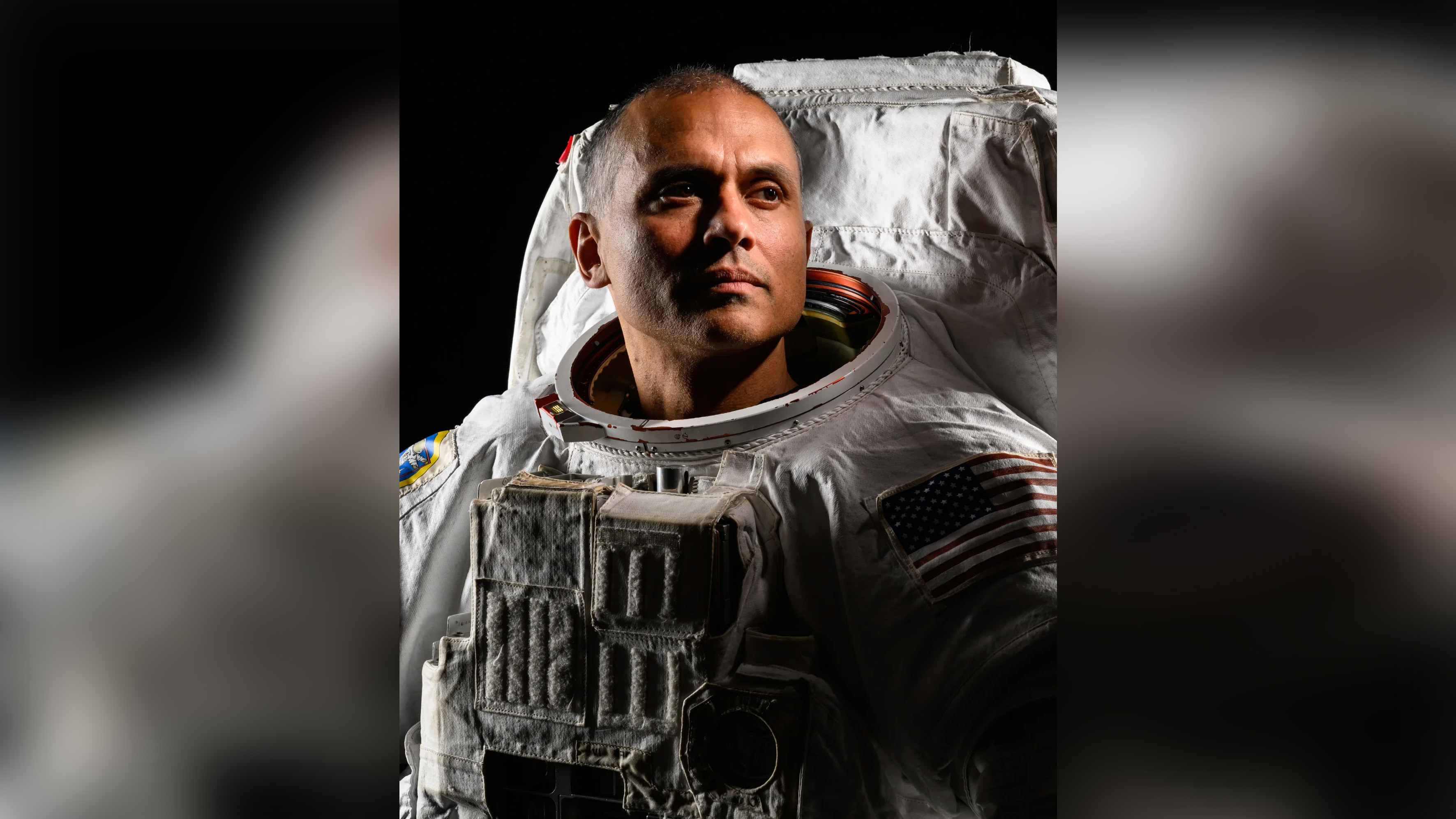 Portrait of NASA astronaut Anil Menon wearing space suit.