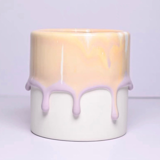 A pastel orange and lavender drip ceramic plant pot