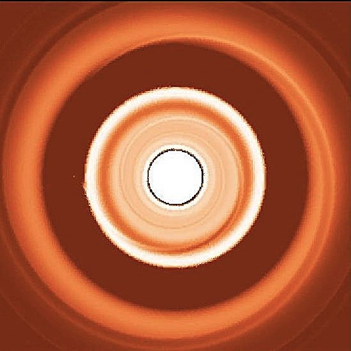 This simulated image shows the dust rings around a migrating exoplanet, with the small dust forming a ring interior to the planet and the large dust forming a ring on the outside of the planet.