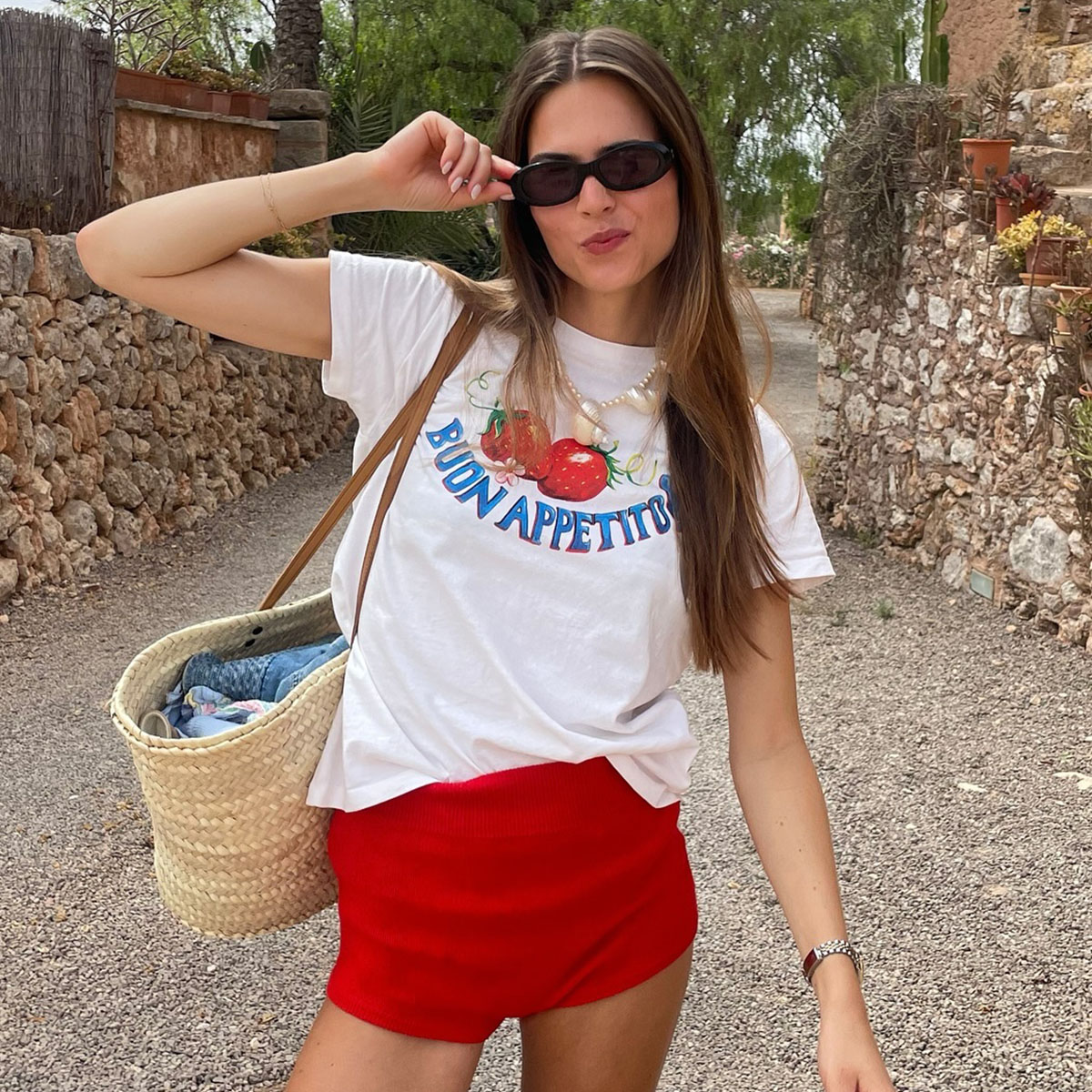 Woman in graphic tee and red shorts