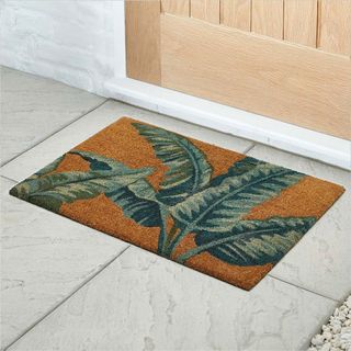 banana leaf doormat on white tile flooring