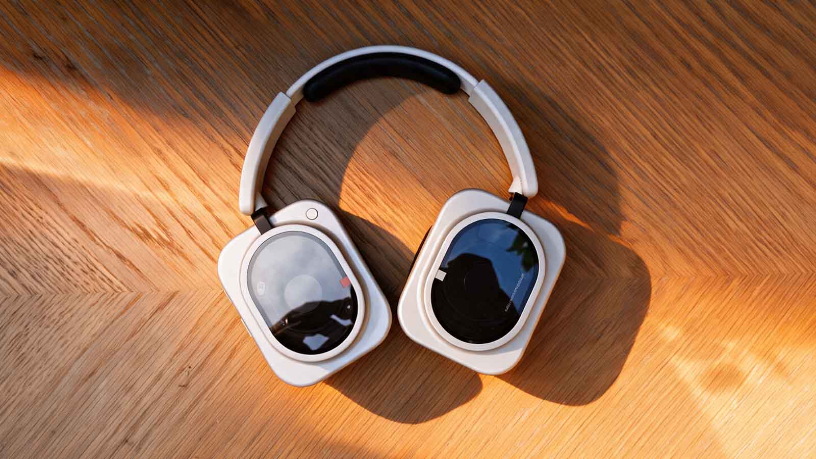 A pair of white headphones on a wooden table