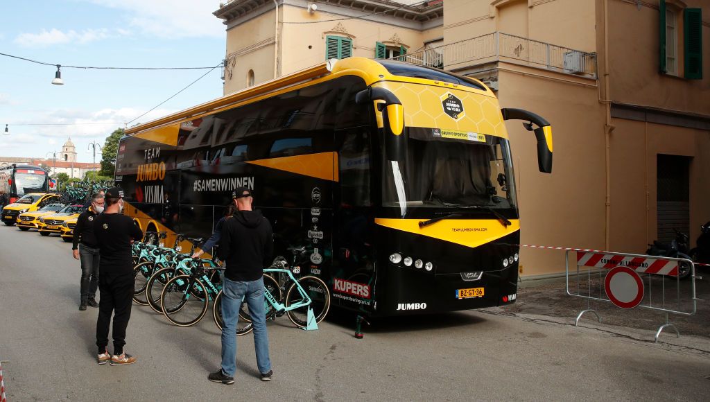 Team Jumbo staff members stand near the vehicles prior the start of the 10th stage of the Giro dItalia 2020 cycling race a 177kilometer route between Lanciano and Tortoreto on October 13 2020 Photo by Luca Bettini AFP Photo by LUCA BETTINIAFP via Getty Images